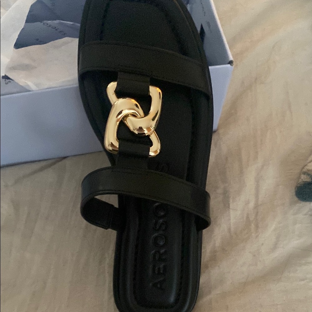 AEROSOLES Black and Gold Slide Sandals with Metal Accent